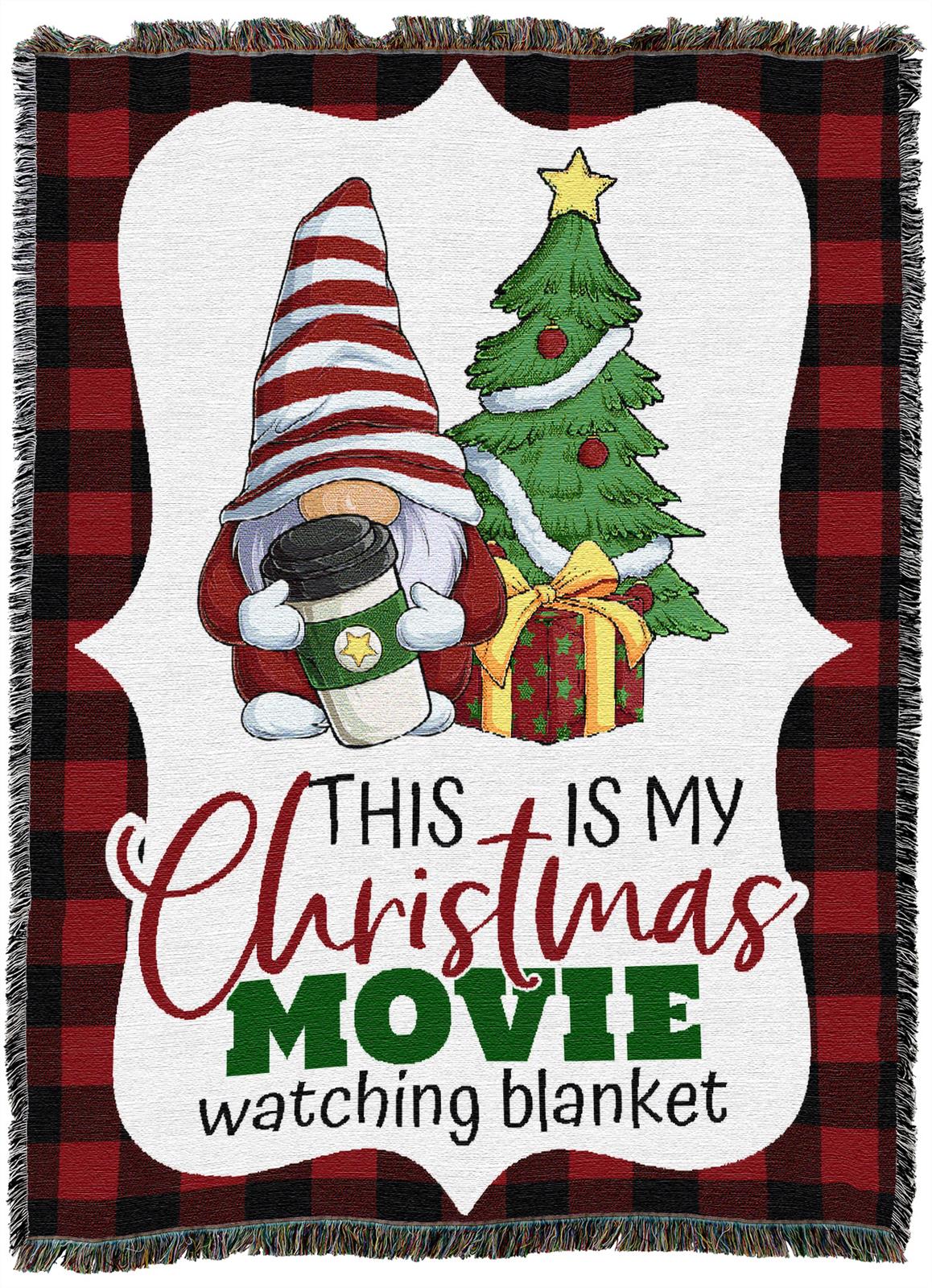 A holiday blanket with a gnome holding cocoa, a Christmas tree, and presents. Text reads: This is my Christmas movie watching blanket on a red and black plaid background.