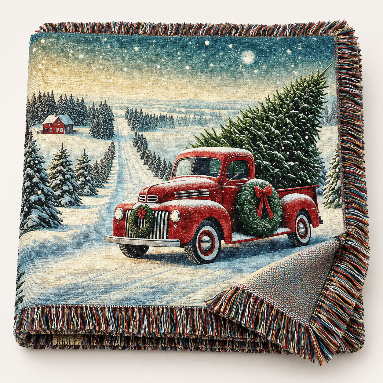 A woven blanket featuring a red vintage truck carrying a Christmas tree and wreath, driving through a snowy countryside with pine trees and a red barn in the background.