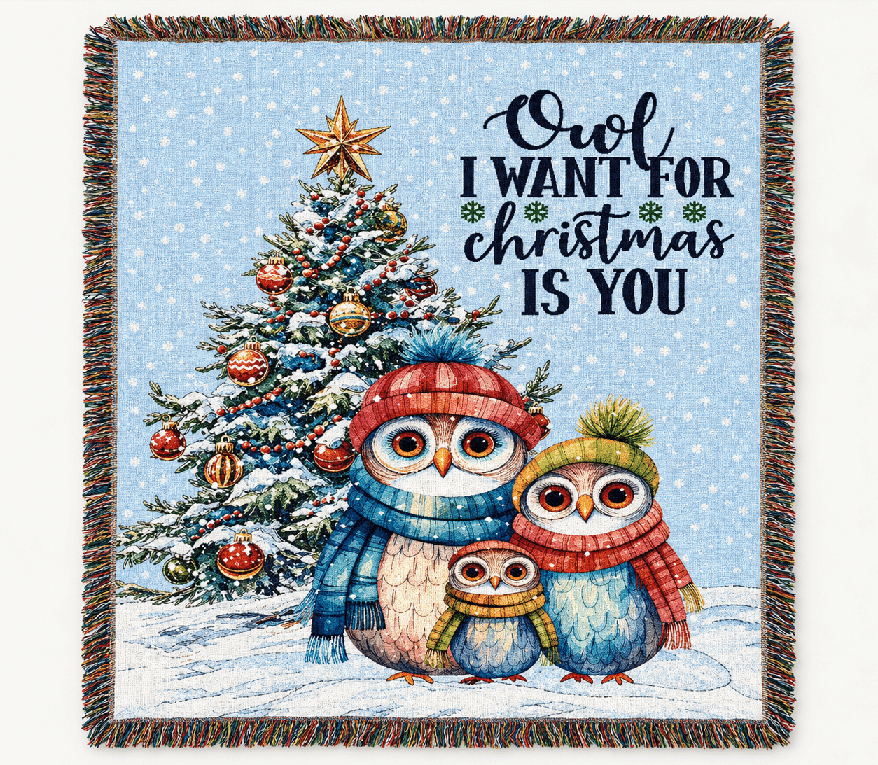 Three owls in winter scarves and hats stand in snow before a decorated Christmas tree. Above them, text reads: Owl I want for Christmas is you. Snow is falling, and the scene feels festive and cheerful.