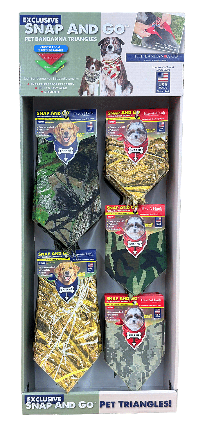 A store display of six Snap And Go pet bandana triangles in various camouflage patterns, featuring images of dogs wearing the bandanas and labeled as exclusive pet triangles.