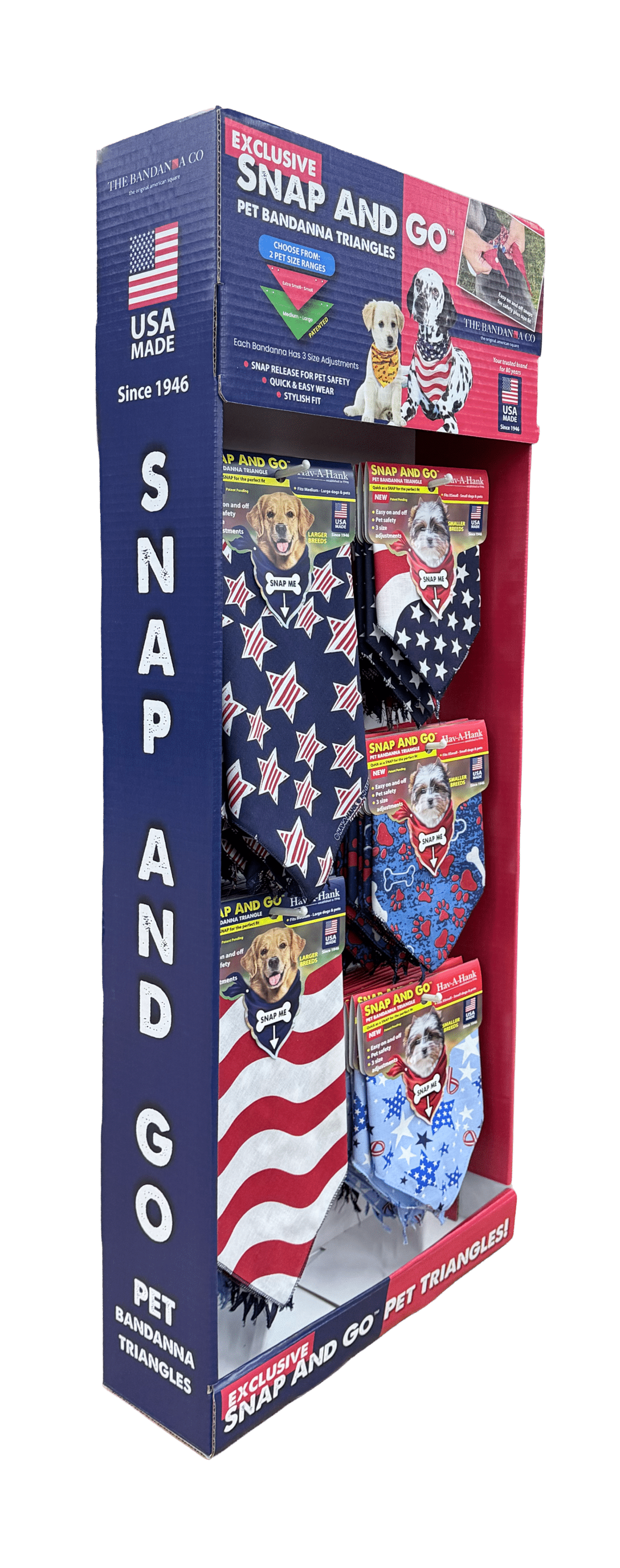 Retail display of Snap and Go pet bandanna triangles with patriotic designs. The stand shows multiple bandannas with dogs on the packaging, featuring stars, stripes, and USA-themed patterns.