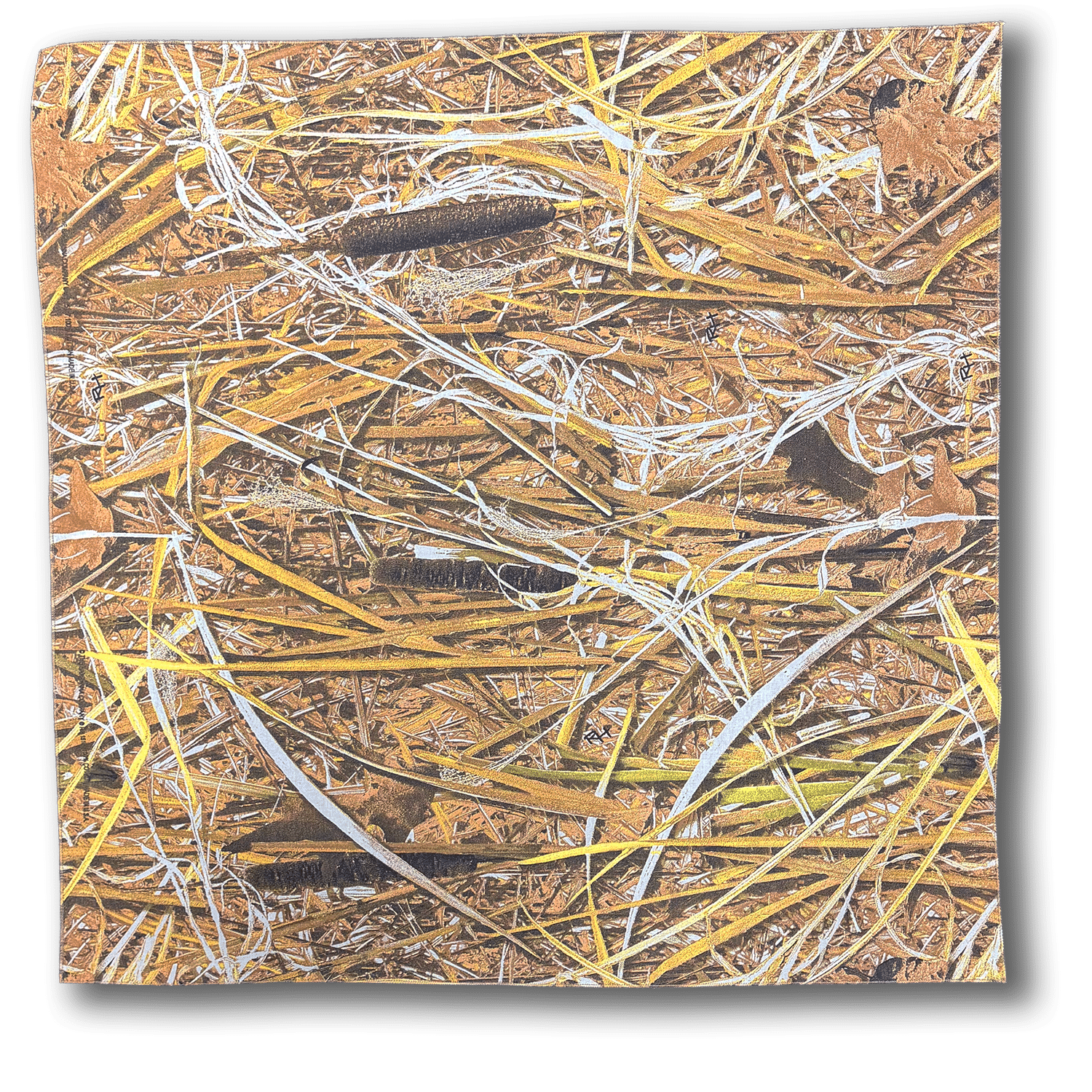 Close-up of a bed of dry straw, grass, and pine needles scattered on brown ground.