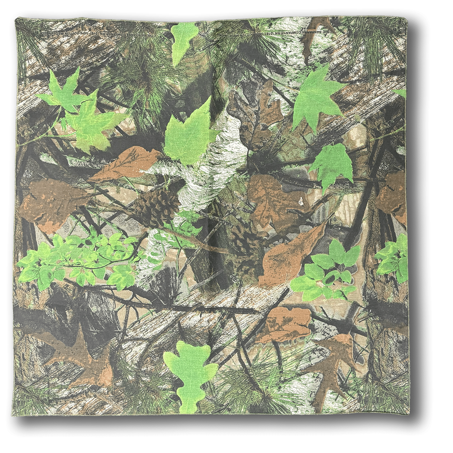 A square fabric with a camouflage pattern featuring green, brown, and tan leaves, branches, and pine needles, designed to blend into a forest environment.